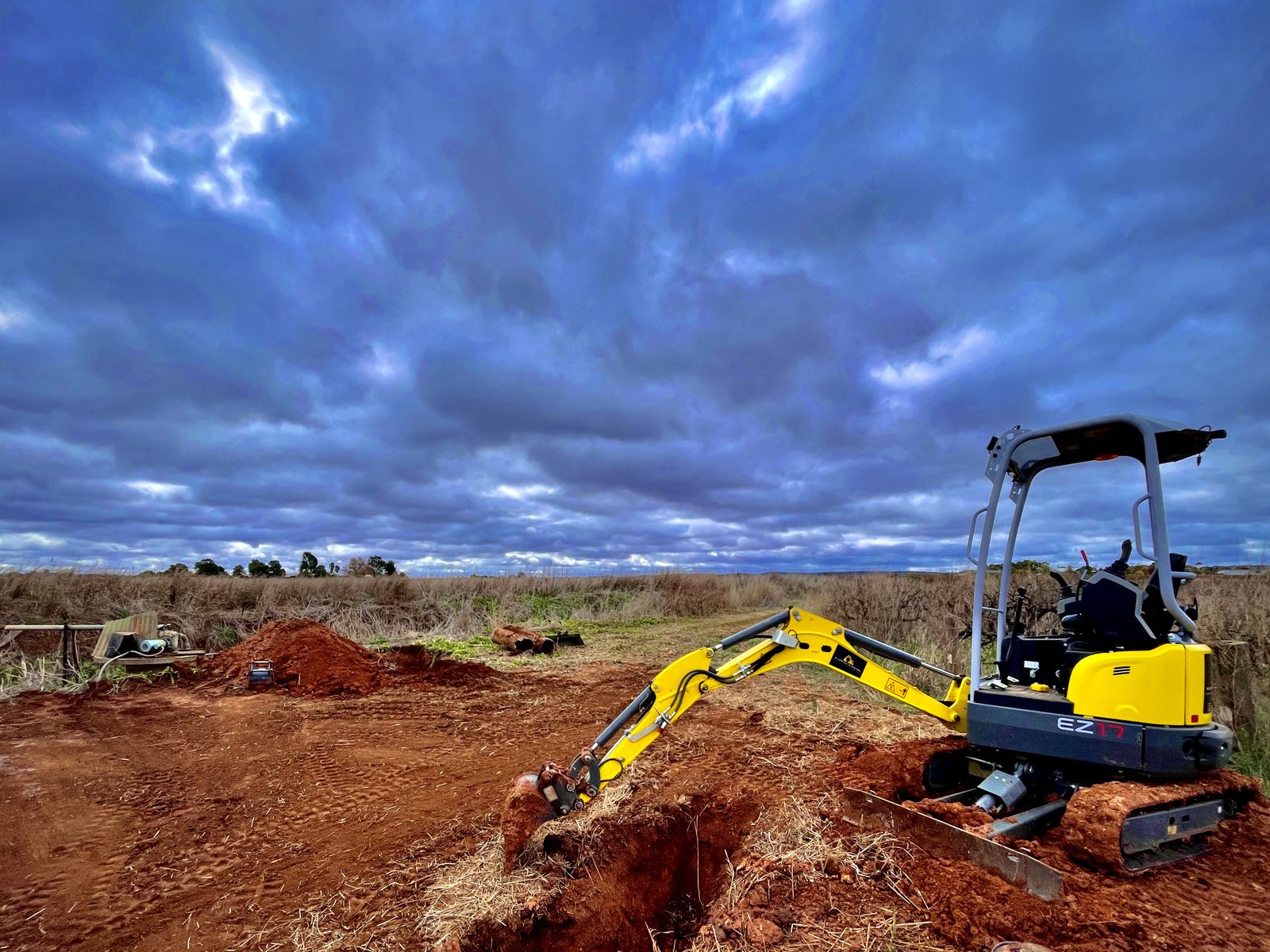 Riverina Diggers 1.7t Wacker Neuson EZ17 zero swing excavator trenching in red soil near Griffith NSW